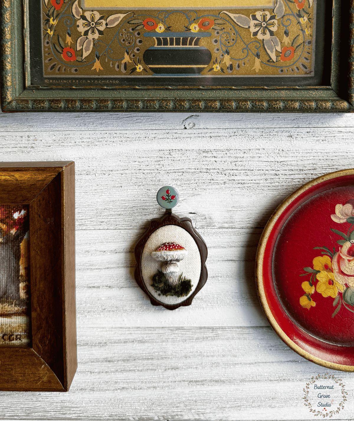 A tiny treasure from the forest floor, stitched by hand. Nestled inside a hand-carved walnut frame, this piece is small enough to wear as a pendant, or to add a bit of magic to your wall as a miniature work of art.  

Dimensions: 1.5" wide × 2" tall
Materials: Hand-stitched embroidery, hand-carved walnut frame

Choose how you would like to enjoy your little woodland treasure:

Please leave a note at checkout with your preference:

• Hand-painted mushroom picture hanger 
• 18" bronze chain with lobster clasp