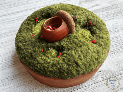 One-of-a-kind 3-inch micro-embroidery featuring a hand-carved acorn surrounded by embroidered moss, British soldier and fairy cup lichens, and tiny woodland details, framed in warm handmade cherry wood frame. 